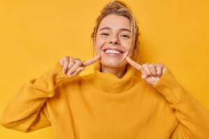 Portrait of woman smiling on orange background